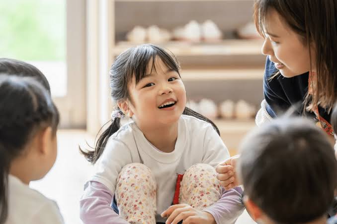 先生やお友達と談笑する女の子